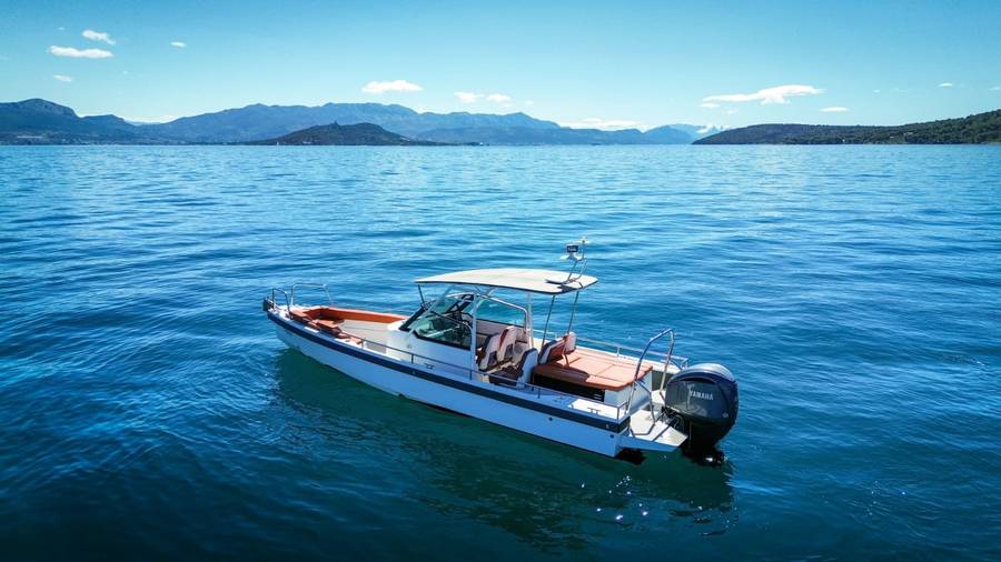 Center console taxi boat anchored near the Split coastline